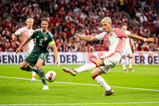 Jonas Wind of Denmark scores the 1-0 goal