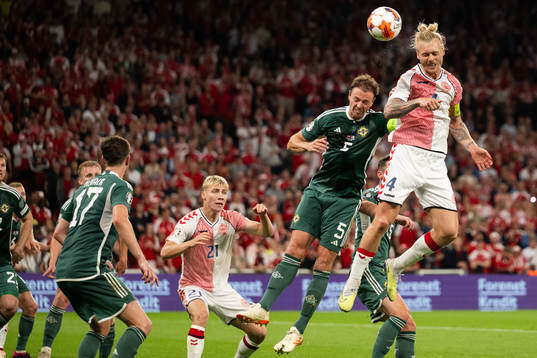 Jonny Evans of Northern Ireland and Simon Kjær of Denmark