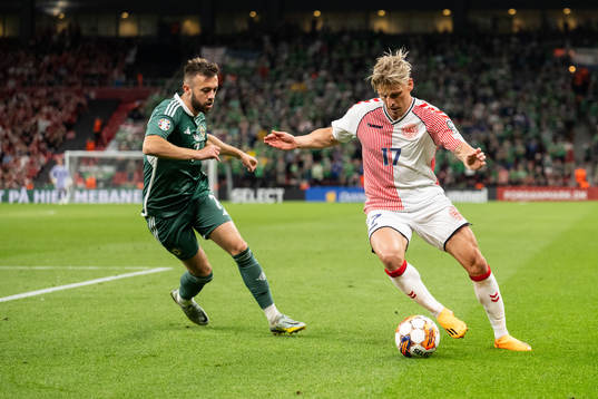 Conor McMenamin of Northern Ireland and Jens Stryger of