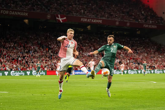 Rasmus Højlund of Denmark and Conor McMenamin of Northern