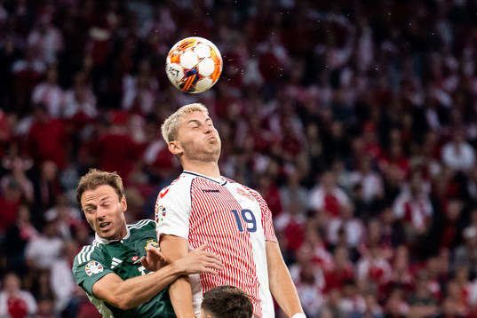 Jonny Evans of Northern Ireland and Jonas Wind of Denmark