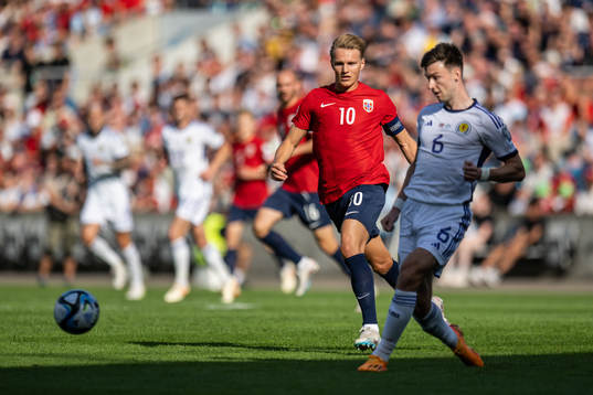 Martin Ødegaard of Norway and Kieran Tierney of Scotland