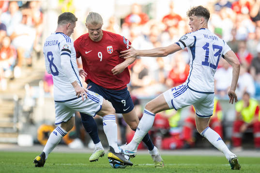 Callum McGregor and Jack Hendry of Scotland against Erling