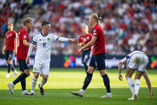 Callum McGregor of Scotland and Erling Braut Haaland of