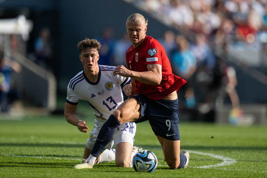 Jack Hendry of Scotland and Erling Braut Haaland of Norway