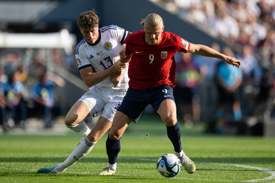 Jack Hendry of Scotland and Erling Braut Haaland of Norway