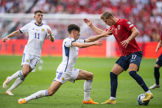 Aaron Hickey of Scotland and Ola Solbakken of Norway