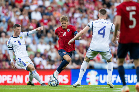 Callum McGregor of Scotland and Martin Ødegaard of Norway
