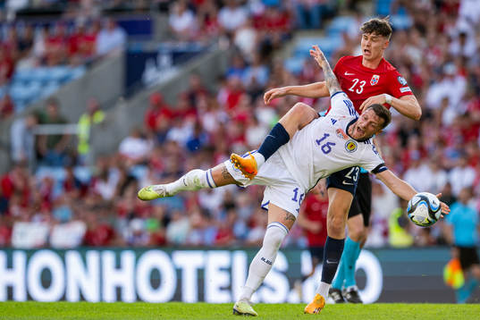 Liam Cooper of Scotland and Jørgen Strand Larsen of Norway
