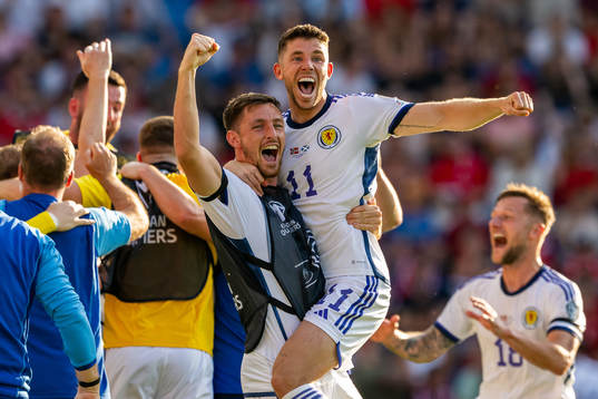 Ryan Christie and players of Scotland celebrate