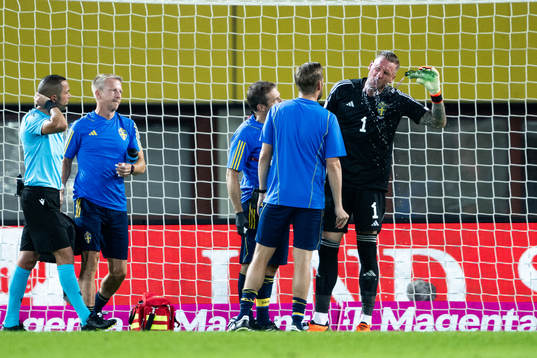 Goalkeeper Robin Olsen of Sweden receives medical attention