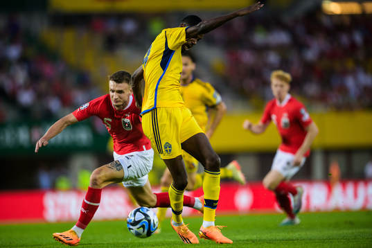 Stefan Posch of Austria trips Alexander Isak of Sweden