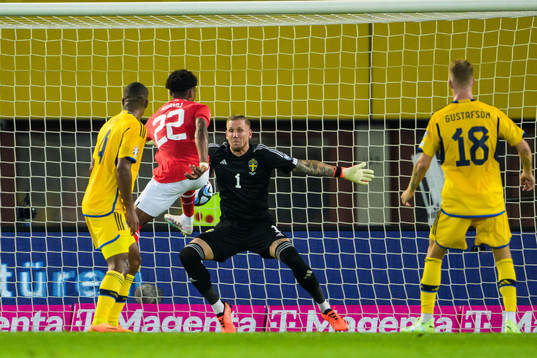 Junior Adamu of Austria and goalkeeper Robin Olsen of Sweden