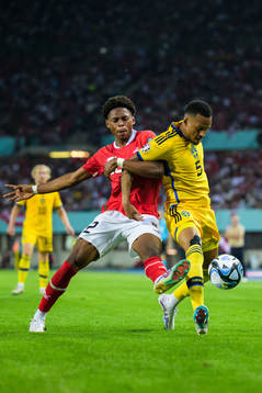 Junior Adamu of Austria and Martin Olsson of Sweden
