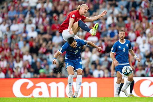 Konstantinos Laifis of Cyprus and Erling Braut Haaland of