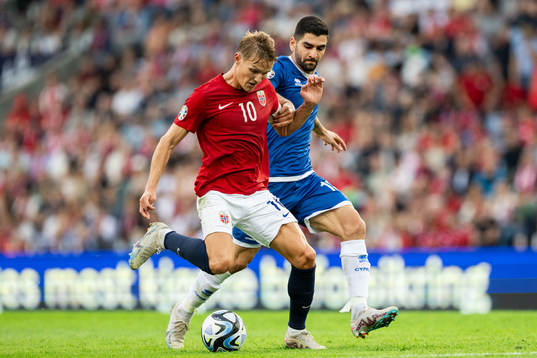 Martin Ødegaard of Norway and Ioannis Kousoulos of Cyprus