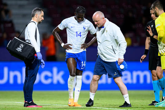 Junior Castello Lukeba of France receives medical attention