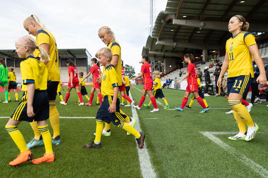 The teams enter the field