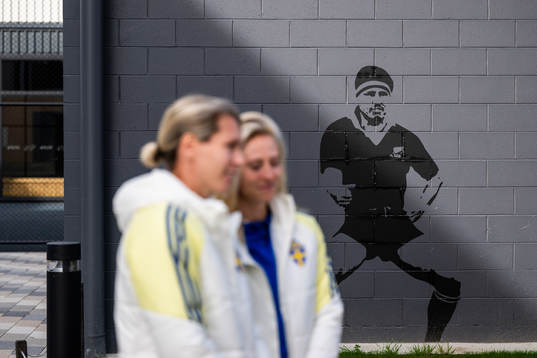 A mural displays a rugby player performing a Haka as