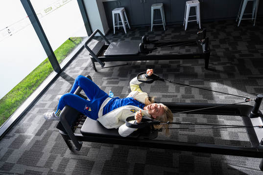 Rebecka Blomqvist lies in a pilates bed