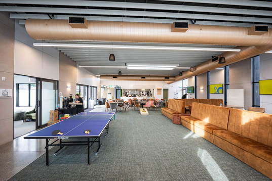 A table tennis table is seen in the eating and social area