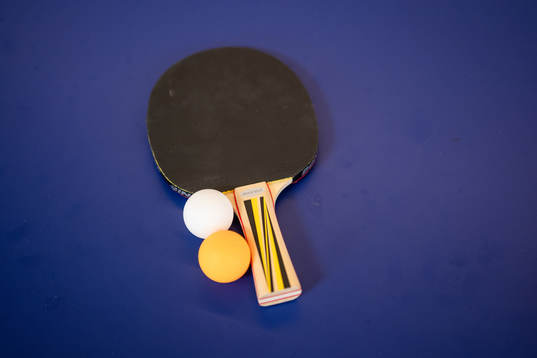 A table tennis racket and balls