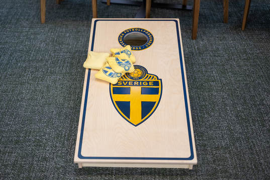 A cornhole game in the social area