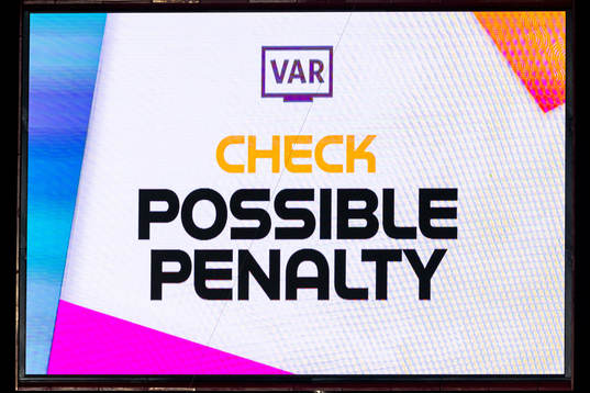 A screen displays a VAR review