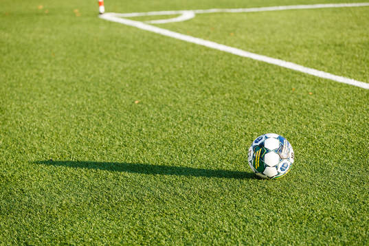 En fotboll ligger på konstgräset