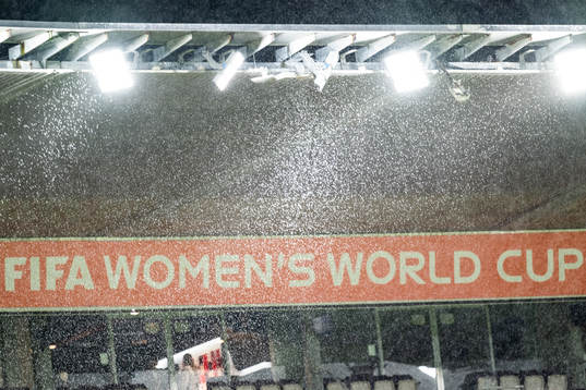The text ”FIFA Women’s World Cup” is seen through rain