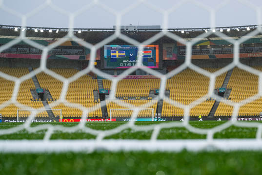 A screen in the stadium displays the kick of time