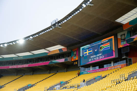 A screen in the stadium displays the kick of time