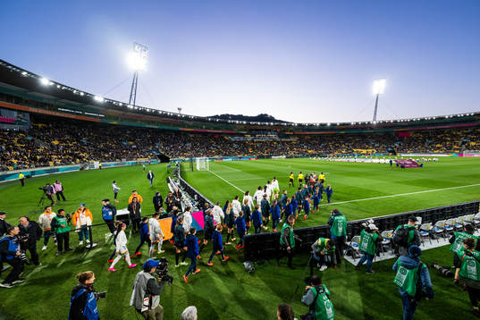 Players of Philippines and of New Zealand enter the pitch