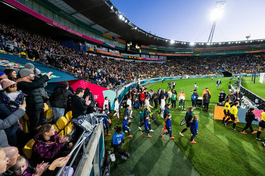 Players of Philippines and of New Zealand enter the pitch