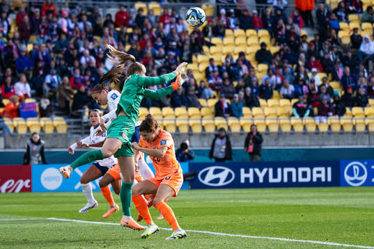 Alex Morgan of USA competes for the ball with goalkeeper