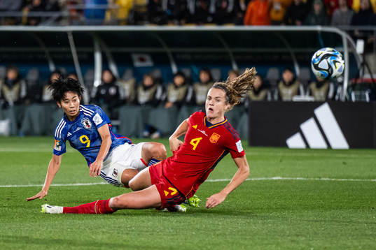 Riko Ueki of Japan scores 2-0 competing with Irene Paredes
