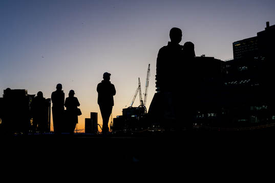 Silhuetts of people walking at sunset