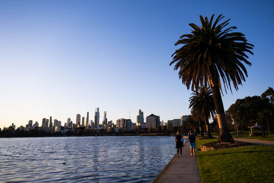 The citys skyline as seen from Albert Park where two people