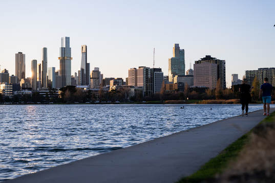 The citys skyline as seen from Albert Park where two people