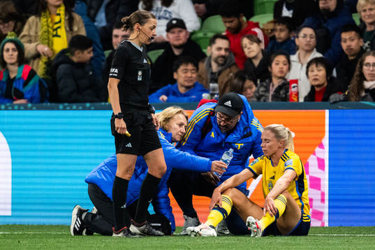 Jonna Andersson of Sweden receives medical treatment from