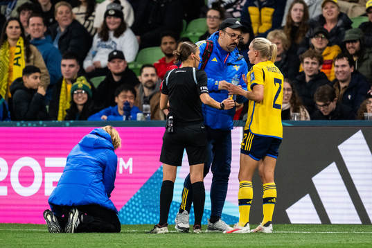 Jonna Andersson of Sweden receives medical treatment from