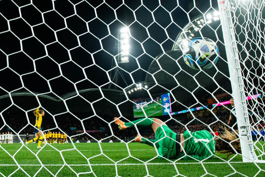Elin Rubensson of Sweden scores a goal behind goalkeeper