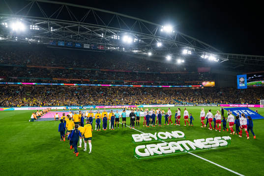 Players of Australia and of Denmark enter the pitch