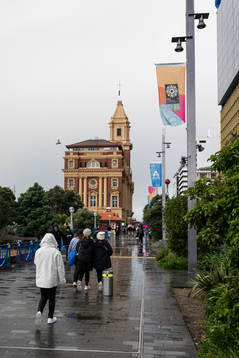 People walk past flags with the logo for the FIFA Women's