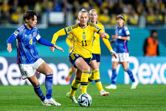 Saki Kumagai of Japan and Stina Blackstenius of Sweden