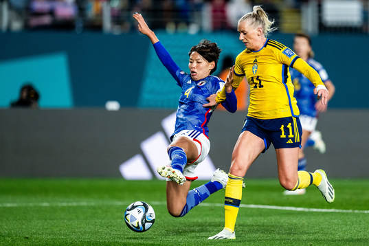 Saki Kumagai of Japan and Stina Blackstenius of Sweden
