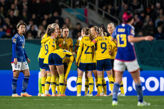Players of Sweden gather at a VAR check