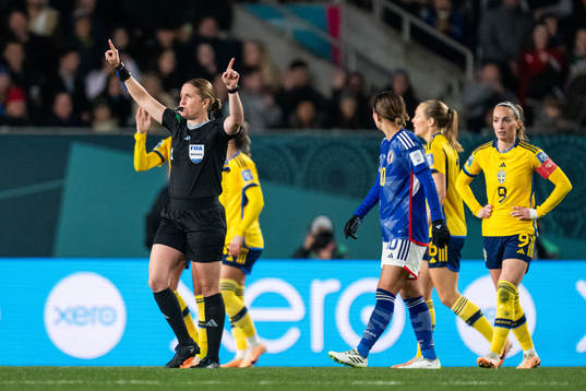 Referee Esther Staubli signals for VAR check and possible