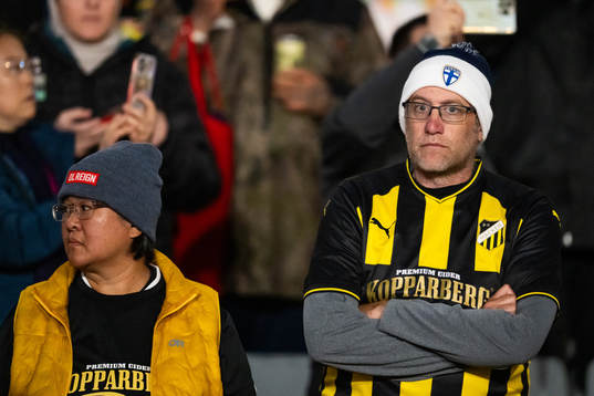 Spectators dressed in jerseys belonging to Swedish football