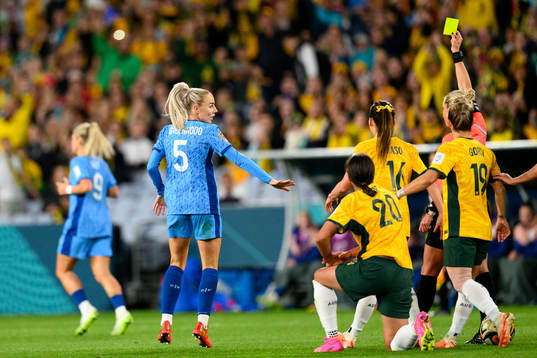 Alex Greenwood of England receives a yellow card